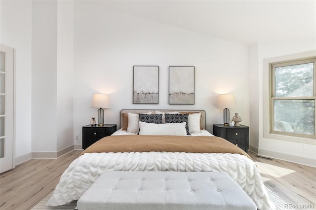 5814 Cole Way, Arvada, CO 80004 - bedroom with vaulted ceiling and light wood-style floors