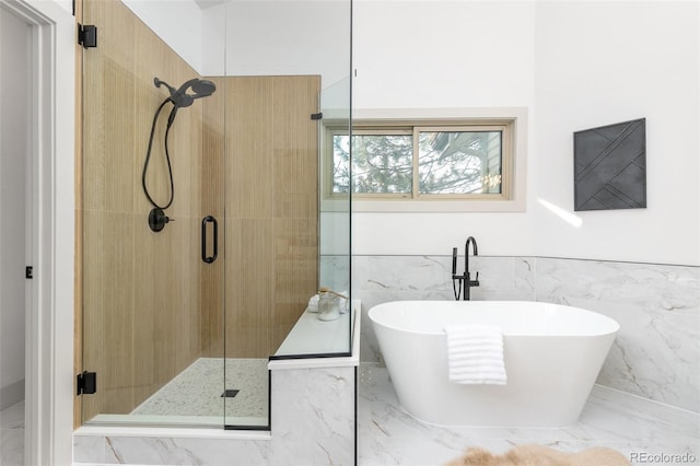 5814 Cole Way, Arvada, CO 80004 - full bathroom featuring marble tiled floors, a shower stall, tile walls, a freestanding bath, and a wainscoted wall