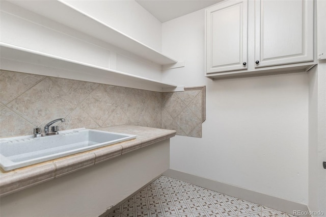 5814 Cole Way, Arvada, CO 80004 - laundry room featuring a sink and light flooring