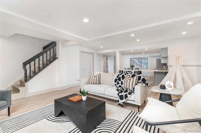 5814 Cole Way, Arvada, CO 80004 - living room featuring stairway, light wood-type flooring, recessed lighting, and a textured ceiling