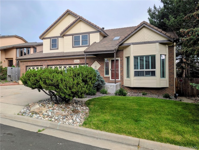 5814 Cole Way, Arvada, CO 80004 - view of front of property with brick siding, a tile roof, and concrete driveway