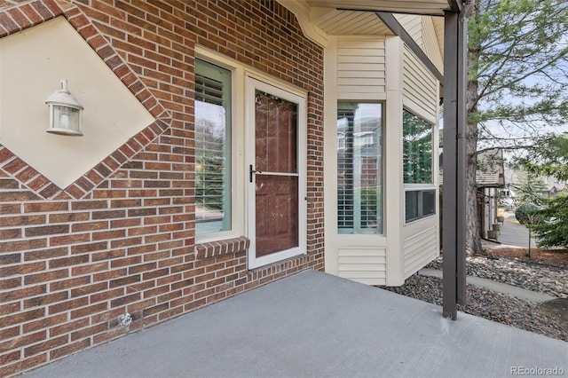 5814 Cole Way, Arvada, CO 80004 - property entrance with a patio area and brick siding