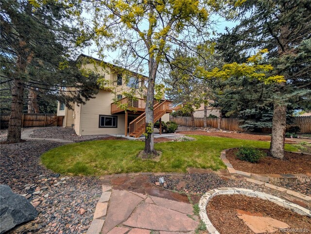 5814 Cole Way, Arvada, CO 80004 - fenced backyard featuring stairs, a wooden deck, and a patio