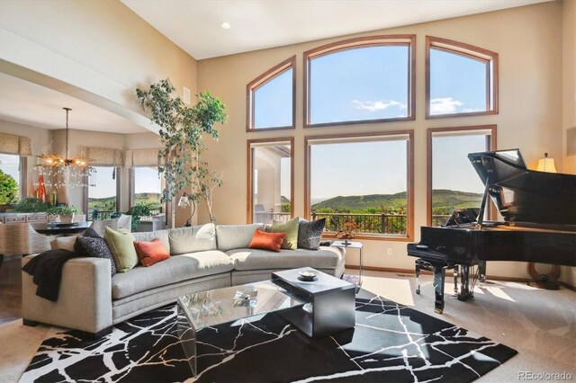 16134 Sandstone Dr, Morrison, CO 80465 - living area featuring a chandelier, carpet flooring, and a towering ceiling