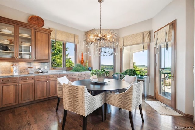 16134 Sandstone Dr, Morrison, CO 80465 - dining space featuring a chandelier and dark wood-style floors