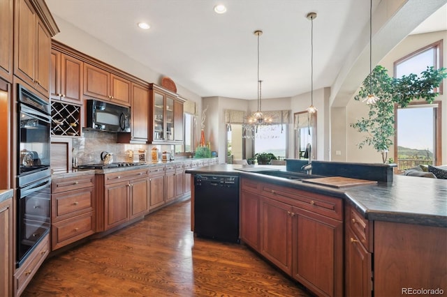 16134 Sandstone Dr, Morrison, CO 80465 - kitchen featuring black appliances, plenty of natural light, dark countertops, recessed lighting, and backsplash