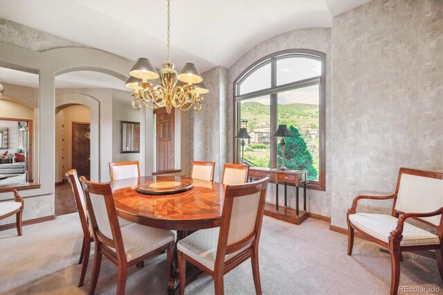 16134 Sandstone Dr, Morrison, CO 80465 - dining room featuring a chandelier, light carpet, arched walkways, and lofted ceiling