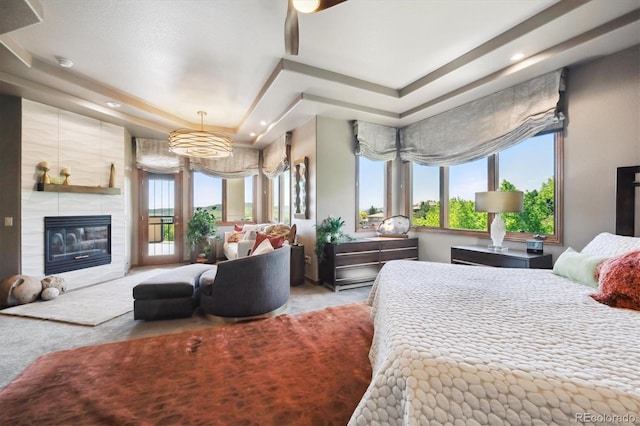 16134 Sandstone Dr, Morrison, CO 80465 - bedroom featuring a tray ceiling, carpet, a tile fireplace, and recessed lighting
