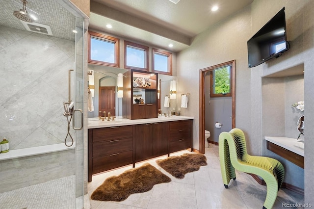 16134 Sandstone Dr, Morrison, CO 80465 - bathroom featuring a stall shower, double vanity, tile patterned floors, and recessed lighting