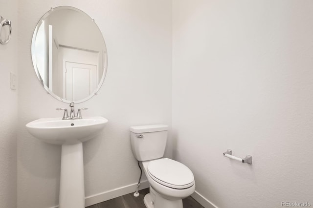2138 S Haleyville Way, Aurora, CO 80018 - bathroom with wood finished floors, toilet, and baseboards