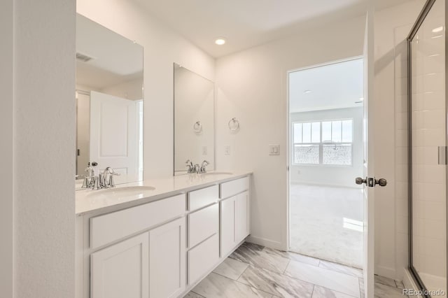 2138 S Haleyville Way, Aurora, CO 80018 - full bath featuring double vanity, a shower with shower door, recessed lighting, and baseboards