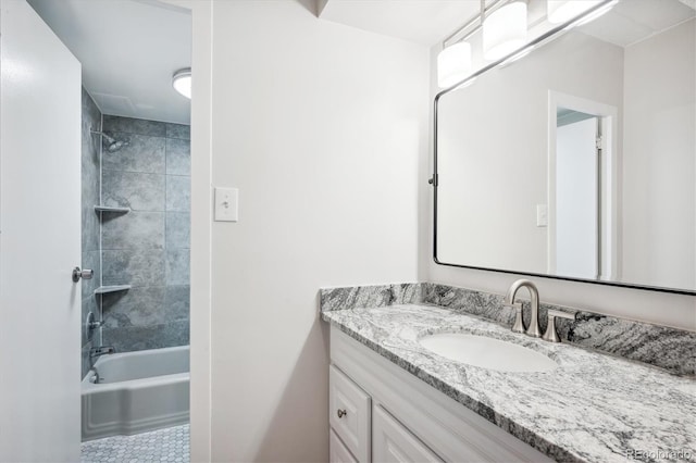 bathroom with vanity and tiled shower / bath