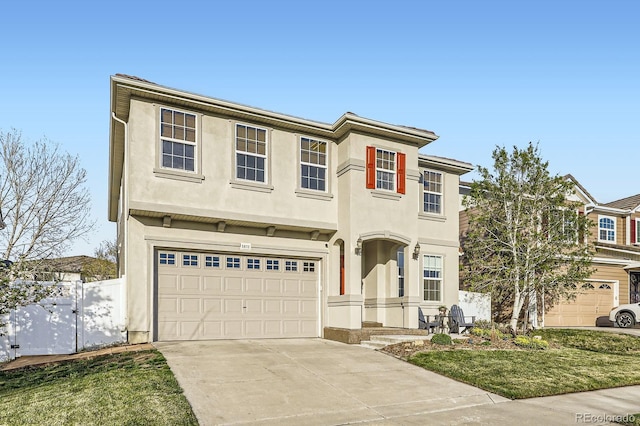 view of front facade with a garage, stucco siding, fence, and concrete driveway