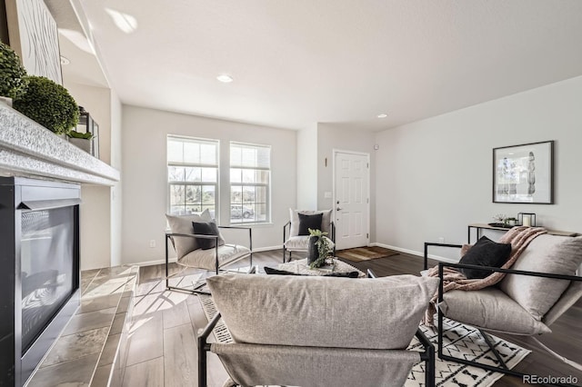 living area with recessed lighting and wood finished floors
