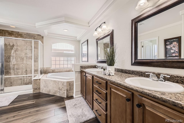 bathroom with a sink, a shower stall, a garden tub, and wood finished floors