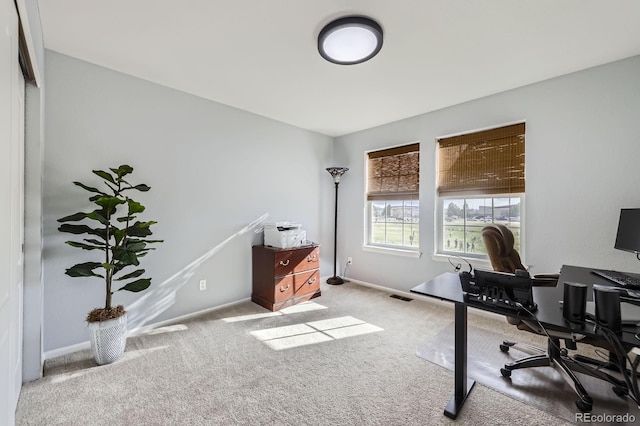carpeted office featuring baseboards and visible vents