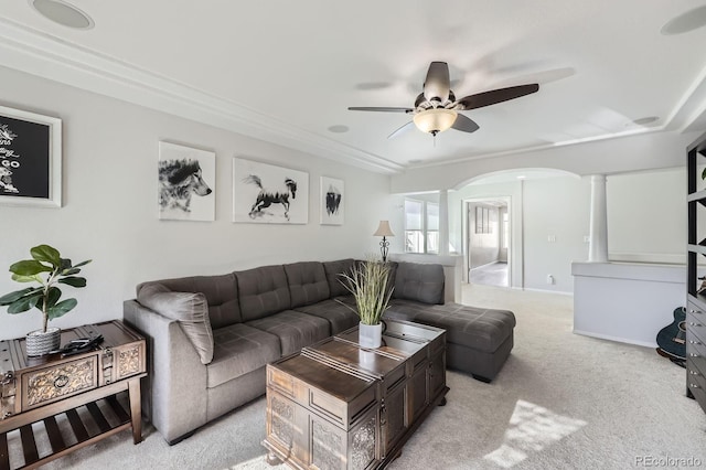 living room with arched walkways, a ceiling fan, light carpet, and ornate columns