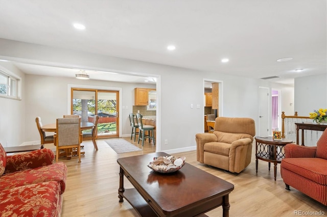 living room featuring light wood-type flooring and plenty of natural light