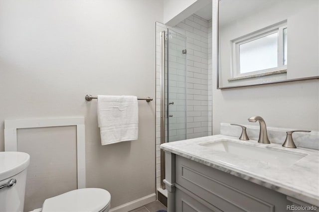 bathroom featuring walk in shower, tile patterned floors, vanity, and toilet