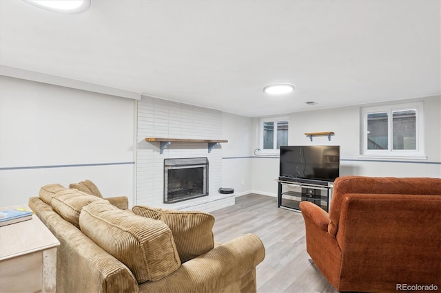 living room featuring light hardwood / wood-style floors and a fireplace