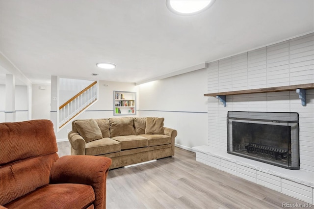 living room featuring a fireplace and light hardwood / wood-style floors