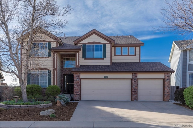 9586 W Victoria Dr, Littleton, CO 80128 - traditional-style house with driveway, roof with shingles, brick siding, and an attached garage