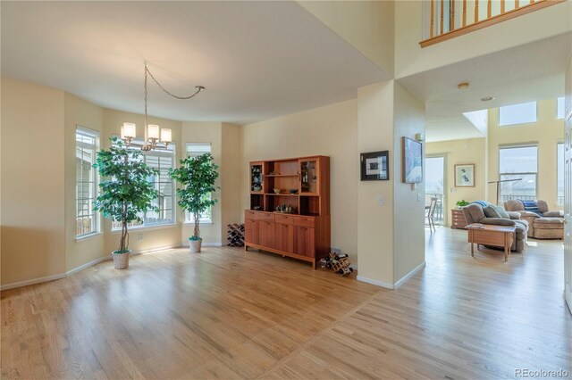 9586 W Victoria Dr, Littleton, CO 80128 - dining room with baseboards, a notable chandelier, and light wood-type flooring