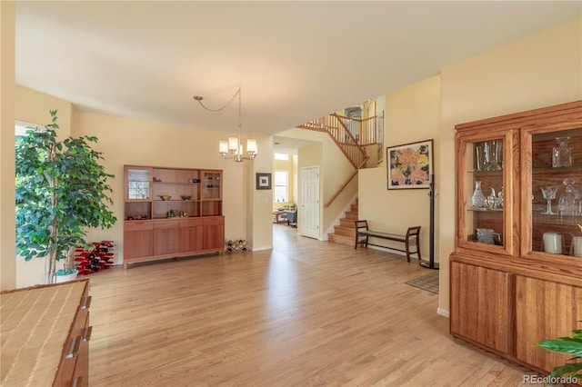 9586 W Victoria Dr, Littleton, CO 80128 - dining room with stairway, an inviting chandelier, and light wood-style floors
