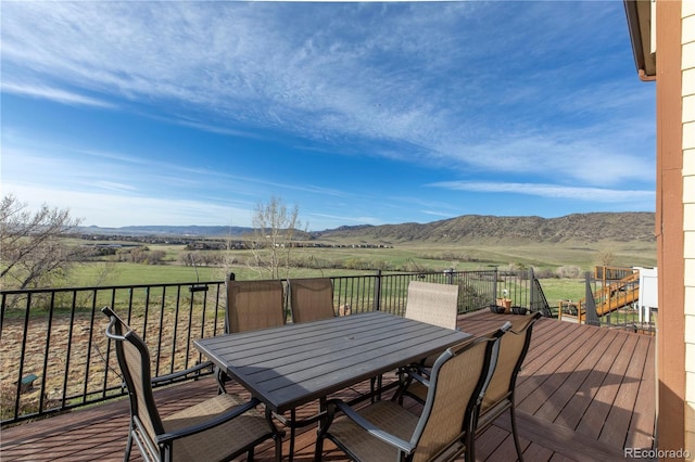 9586 W Victoria Dr, Littleton, CO 80128 - wooden deck featuring a mountain view, a rural view, and outdoor dining area