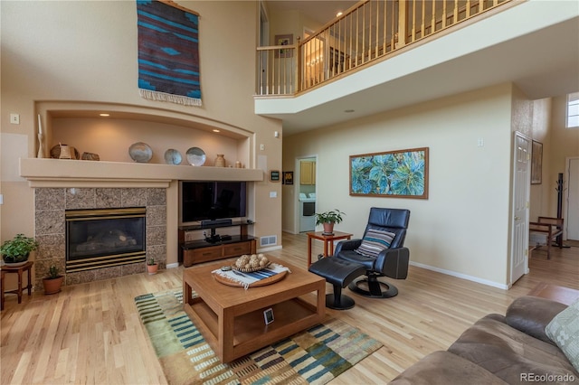 9586 W Victoria Dr, Littleton, CO 80128 - living room with baseboards, visible vents, a towering ceiling, and wood finished floors