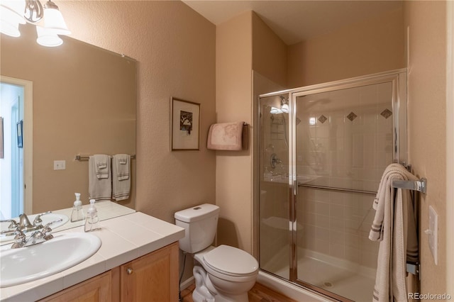 9586 W Victoria Dr, Littleton, CO 80128 - full bath featuring vanity, toilet, a chandelier, and a shower stall