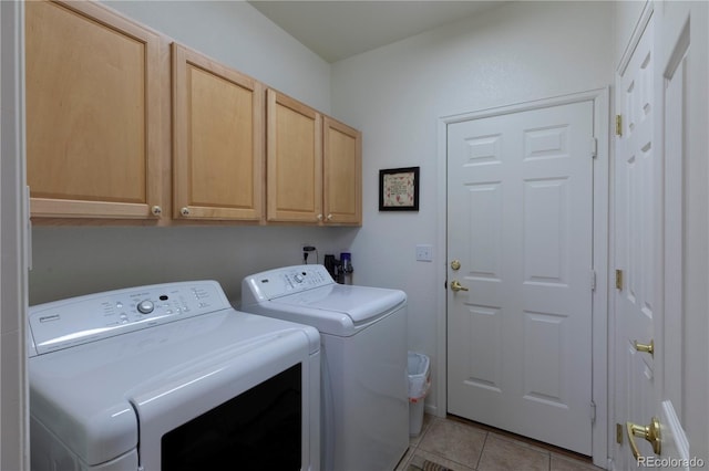 9586 W Victoria Dr, Littleton, CO 80128 - laundry area featuring washing machine and dryer, cabinet space, and light tile patterned floors