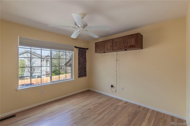 9586 W Victoria Dr, Littleton, CO 80128 - unfurnished room featuring baseboards, light wood-style floors, visible vents, and a ceiling fan