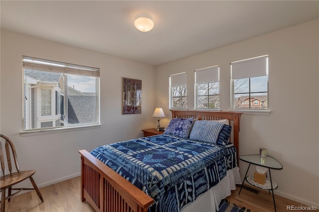 9586 W Victoria Dr, Littleton, CO 80128 - bedroom featuring wood finished floors and baseboards