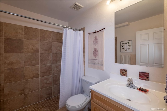 9586 W Victoria Dr, Littleton, CO 80128 - full bath featuring toilet, visible vents, vanity, and a tile shower