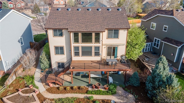 9586 W Victoria Dr, Littleton, CO 80128 - rear view of house featuring roof with shingles, a residential view, a wooden deck, and stairs