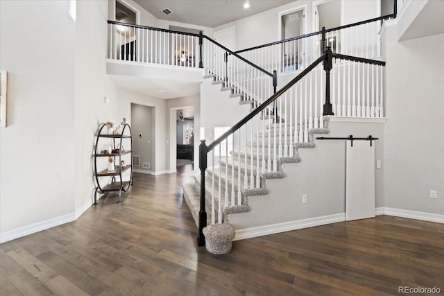3745 Spanish Oaks Trl, Castle Rock, CO 80108 - staircase featuring wood finished floors and a towering ceiling