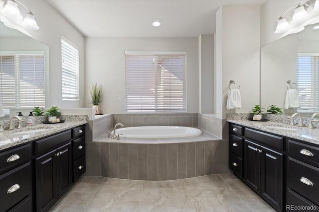3745 Spanish Oaks Trl, Castle Rock, CO 80108 - bathroom featuring two vanities, a bath, tile patterned floors, and plenty of natural light