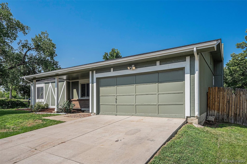 view of front of house with a garage and a front lawn