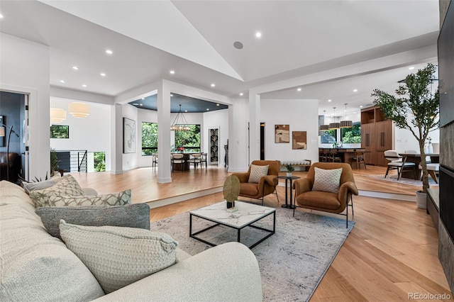 living room featuring vaulted ceiling and light hardwood / wood-style flooring