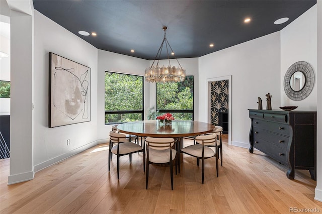 dining room with a chandelier and light hardwood / wood-style flooring