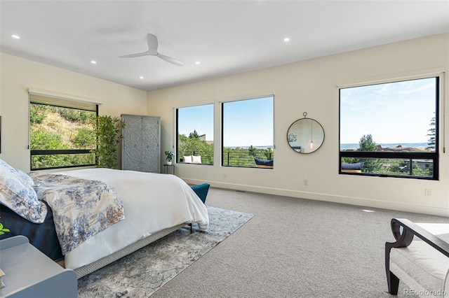 bedroom with multiple windows, carpet floors, and ceiling fan