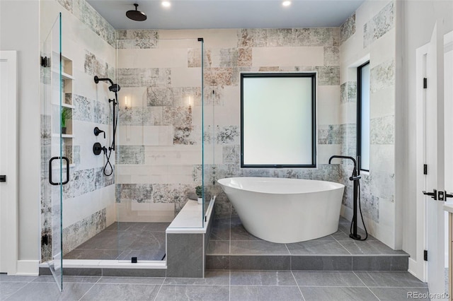 bathroom featuring tile walls, tile patterned flooring, and shower with separate bathtub