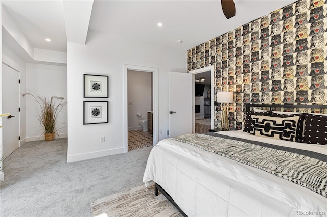 carpeted bedroom featuring ceiling fan and connected bathroom