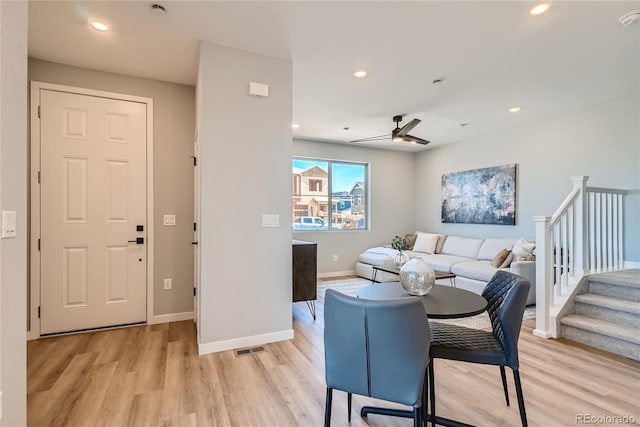 living room with ceiling fan and light hardwood / wood-style floors