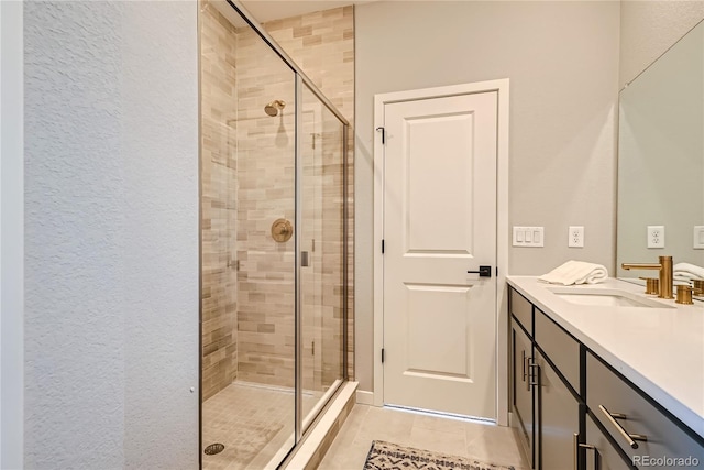 bathroom with tile patterned floors, vanity, and an enclosed shower