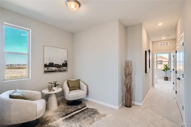 living area with light colored carpet