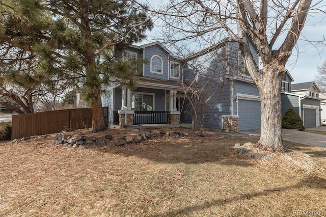 view of front of property featuring a garage, a front yard, and a porch