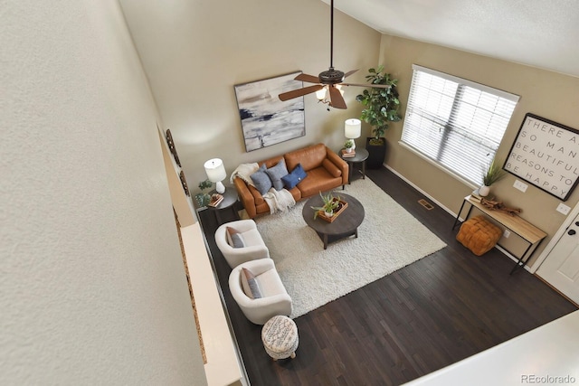 living room featuring lofted ceiling, baseboards, a ceiling fan, and wood finished floors
