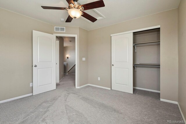 unfurnished bedroom with carpet flooring, a closet, baseboards, and visible vents